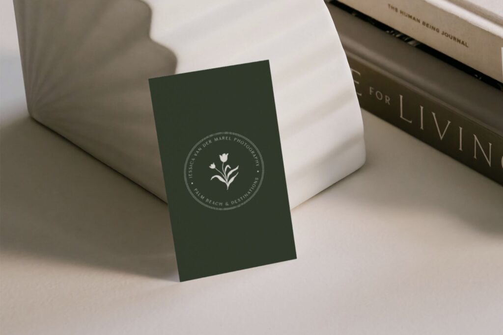 Dark green business card design featuring a monogram logo