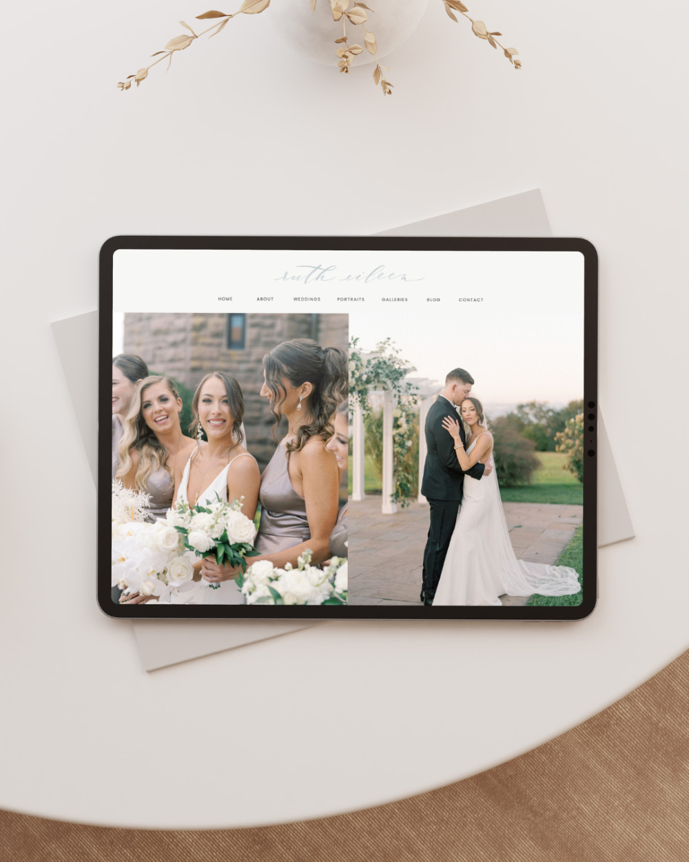 Tablet displaying an elegant Showit wedding photographer website design featuring bridesmaids and a couple on their wedding day. -- website refresh.