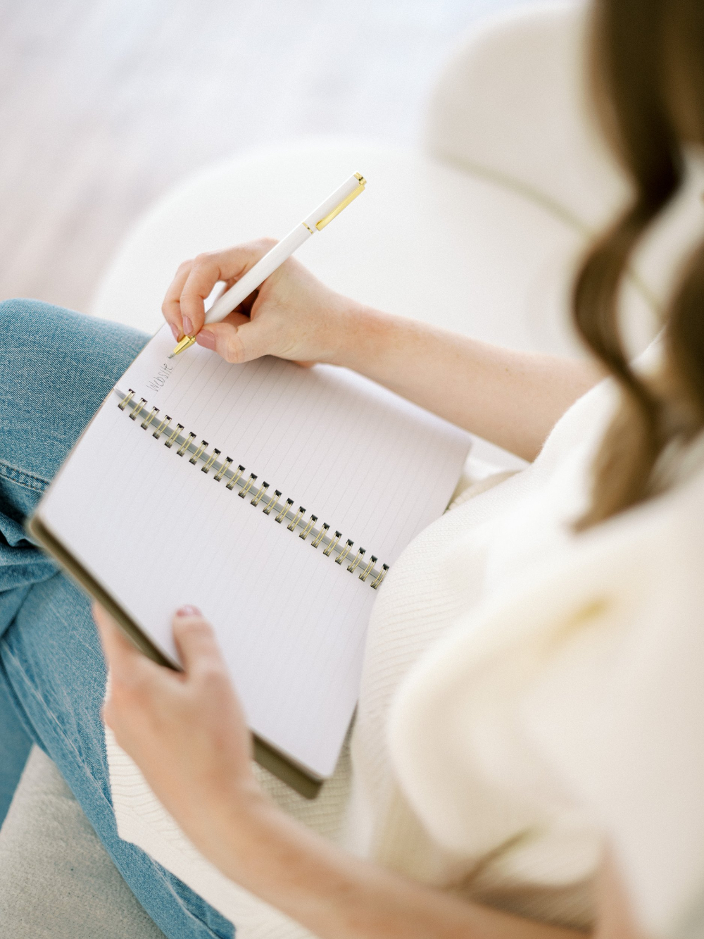 A close-up of someone writing in a notebook while planning content. A quiet moment of outlining ideas to support future Showit SEO growth.