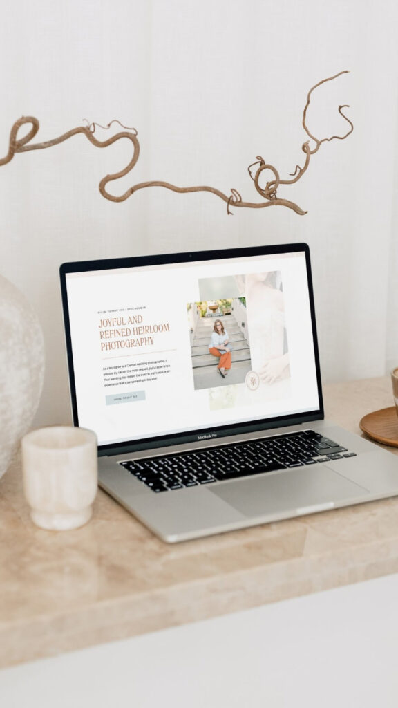 Laptop displaying a wedding photography website example while comparing Showit vs Wix website design platforms.