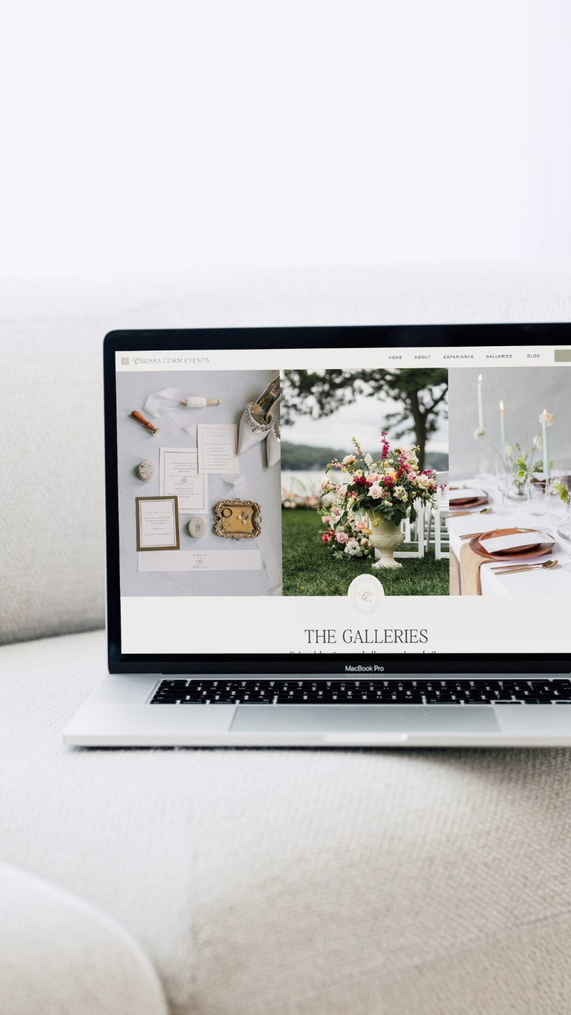 Laptop displaying wedding website homepage with soft neutral tones and elegant, minimal layout design