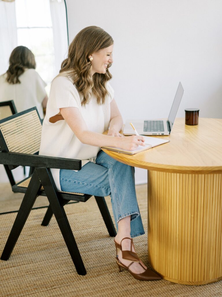 Designer reviewing Showit vs WordPress options while planning a wedding business website