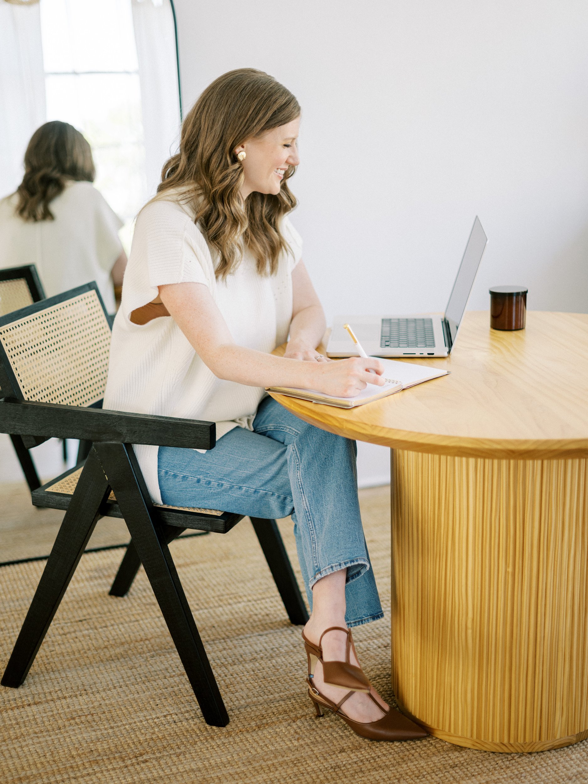 Designer reviewing Showit vs WordPress options while planning a wedding business website