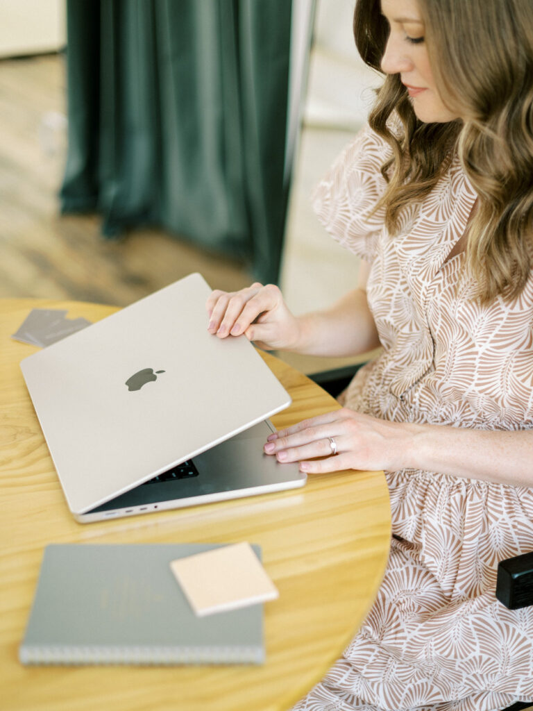 Person opening a laptop while exploring the Showit website builder for a wedding business website.
